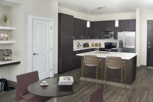 Kitchen and dining with dark finish and built-in desk at Camden Franklin Park