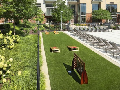 Poolside game area with cornhole at Camden Franklin Park apartments in Franklin, TN