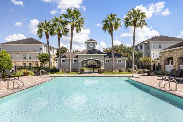 Resort-style pool with Lounge Seating at Camden Downs at Cinco Ranch in Katy, TX. 