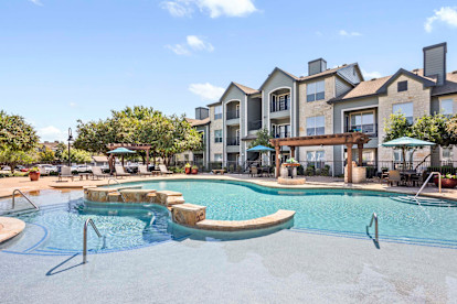 Resort-style pool with tanning ledge at Camden Amber Oaks apartments in Austin, TX