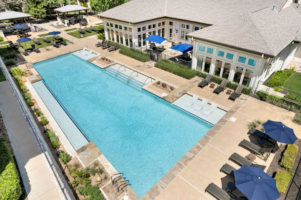 Aerial view of resort-style pool and clubhouse at Camden La Frontera apartments in Round Rock, TX