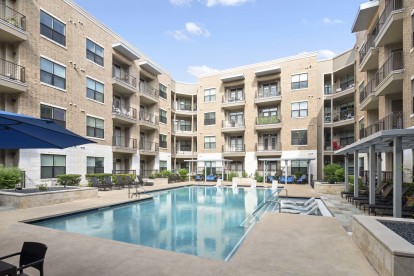 Resort-style pool with in-water loungers at Camden Lamar Heights 