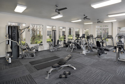 Fitness center with strength training and cardio equipment at Camden Lago Vista apartments in Orlando, Florida.