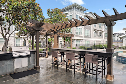 BBQ grills by the pool at Camden Northpointe apartments in Tomball, TX