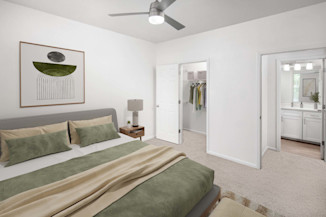 Modern style bedroom with plush carpet and ceiling fan at Camden Spring Creek Apartments in Spring, Tx