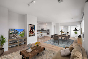 Penthouse open concept living and dining area alongside kitchen