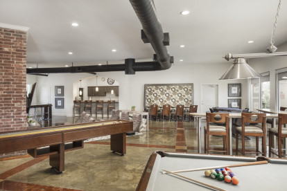 Resident lounge with billiards and shuffleboard at Camden Farmers Market Apartments in Dallas, TX