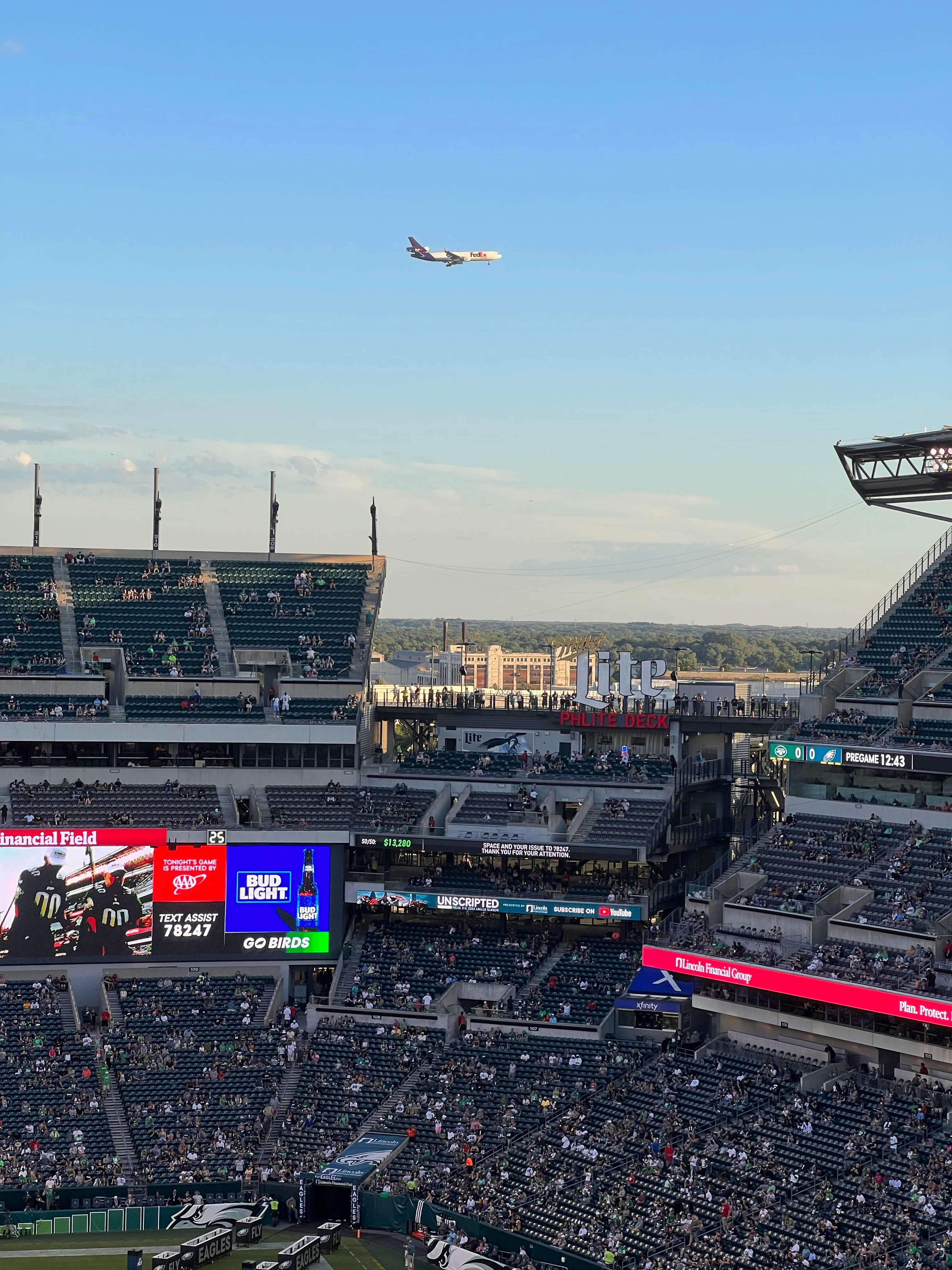 https://www.pexels.com/photo/airplane-flying-in-the-sky-over-stadium-13394825/