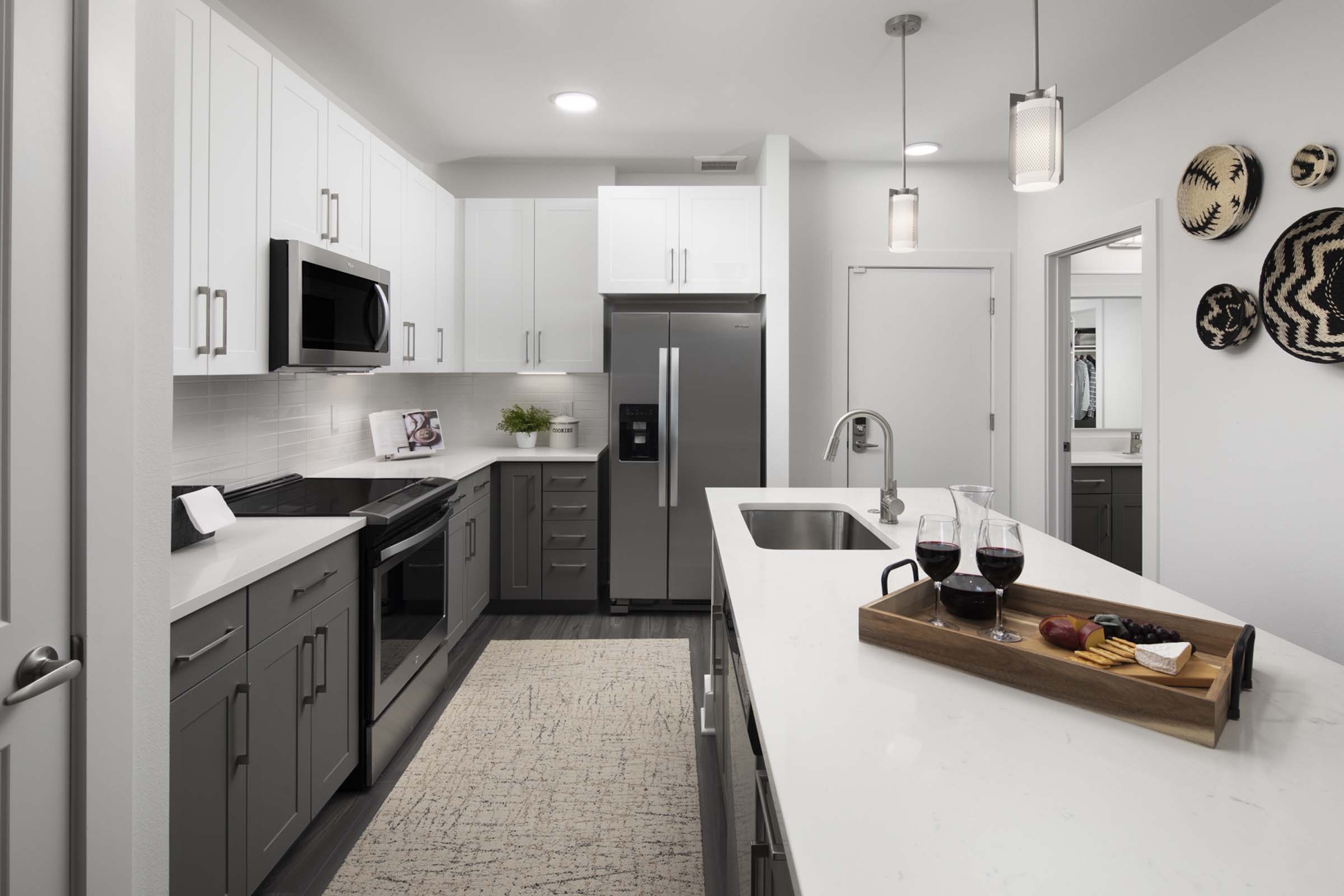 Desert modern style kitchen island with stainless steel appliances and gray vein quartz countertops