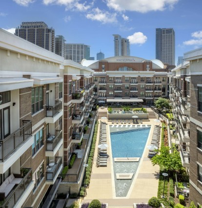 Aerial view of resort-style pool and sundeck with American Airlines Center in the background at Camden Victory Park apartments in Dallas, TX