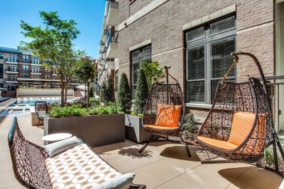 Outdoor lounge with seating alongside pool