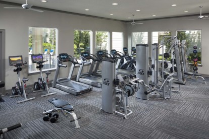 24-hour fitness center with cardio and strength training equipment