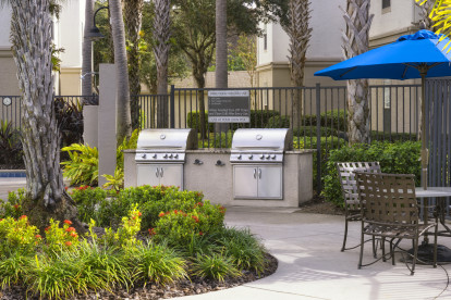 BBQ grills by the pool at Camden Lago Vista apartments in Orlando, FL