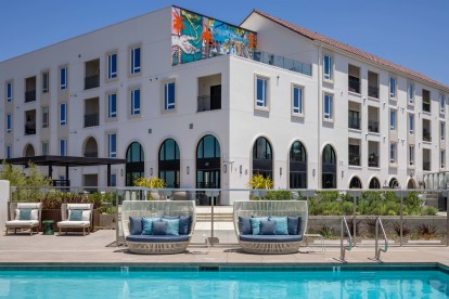 Camden Hillcrest Apartments San Diego CA pool with daybeds and arch windows and mural in the background