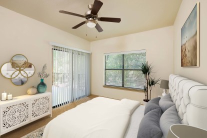 Bedroom with ceiling fan and sliding glass door access to private patio