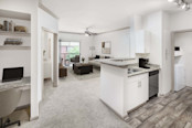 Kitchen and living area with built-in desk at Camden Holly Springs apartments in Houston, TX
