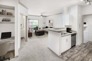 Kitchen and living area with built-in desk at Camden Holly Springs apartments in Houston, TX