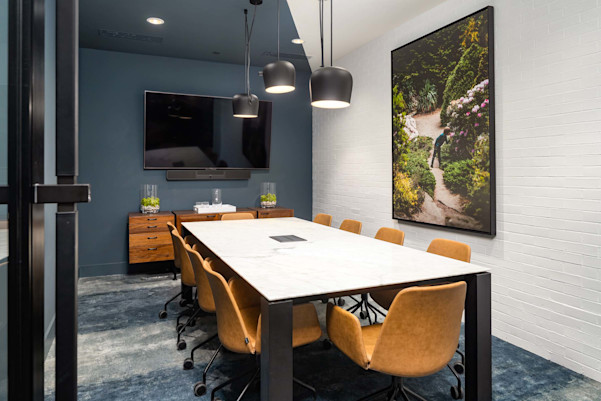 Community workspace private conference room with large table and tv at Camden West Nashville apartments in Nashville, TN