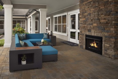 Enjoy the serenity at our outdoor lounge, featuring a fireplace just right outside our Resident Lounge