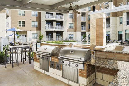 Poolside outdoor grills at Camden Lincoln Station Apartments in Lone Tree, CO