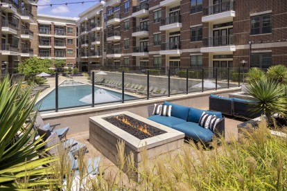 Outdoor lounge with fire pits overlooking the pool at Camden Victory Park apartments in Dallas, TX