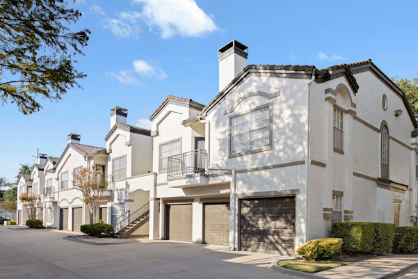 Building exterior with garages and balconies at Camden Legacy Creek