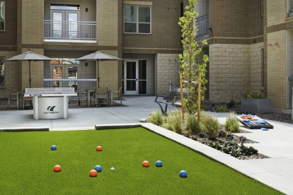 Outdoor game courtyard at Camden Lincoln Station Apartments in Lone Tree, CO