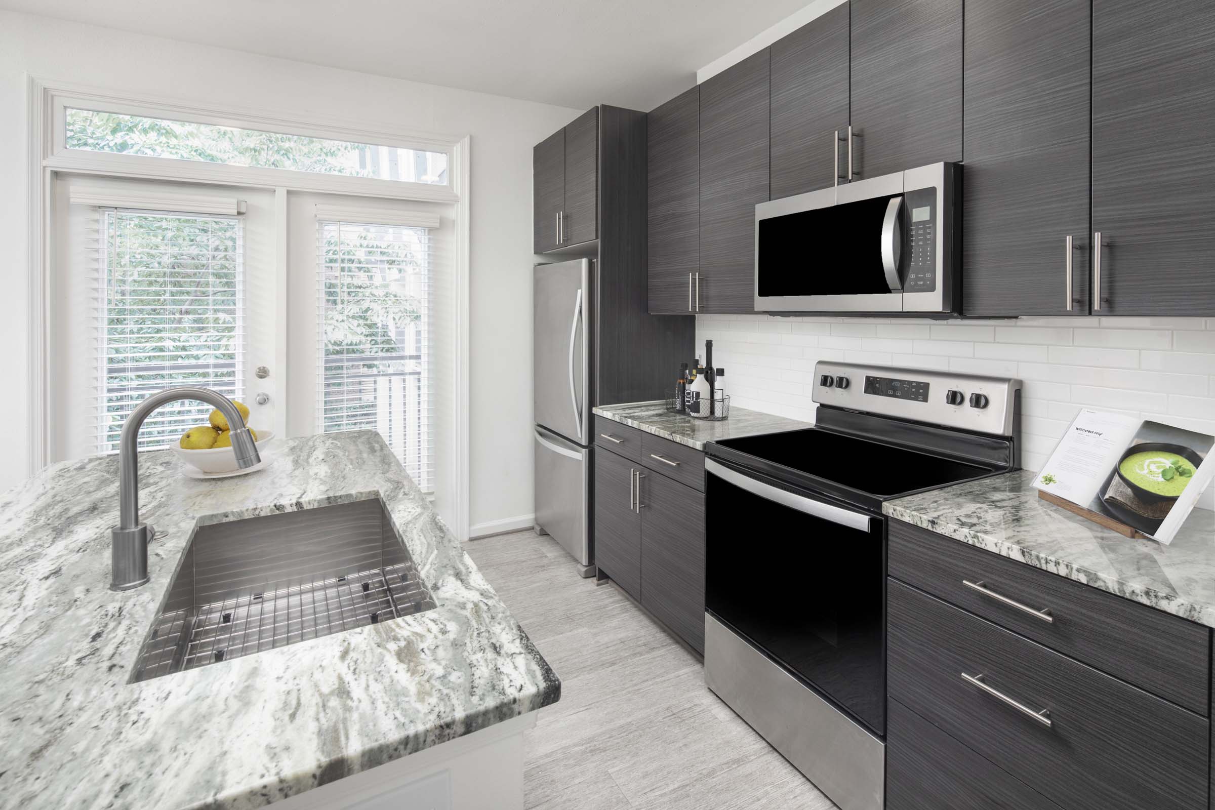 Kitchen with granite countertops and stainless steel appliances at Camden Monument Place in Fairfax, VA
