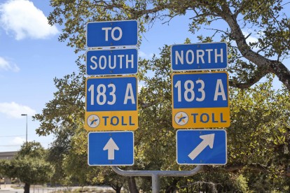 Highway 183 and toll road signs near Camden Brushy Creek apartments in Cedar Park, TX