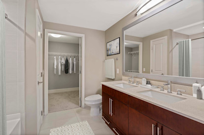 Cherry wood design scope bathroom with double vanity and walk in closet