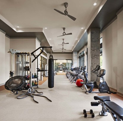 24 hour fitness center with boxing bag ropes and cardio equipment