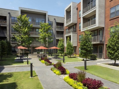 Lush courtyard with grills and seating at Camden Design District apartments in Dallas, TX