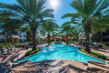 Beach style pool with grilling areas