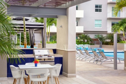 Poolside BBQ grills and dining areas at Camden Brickell apartments in Miami, FL