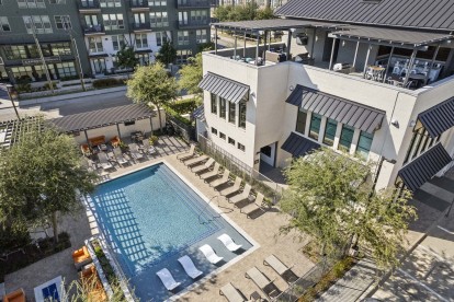 Aerial view of Villas pool and amenity building with rooftop lounge at Camden Greenville