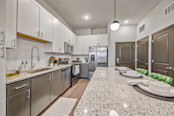 Kitchen with two toned cabinetry and stainless steel appliances at Camden Brandon apartments in Brandon, FL