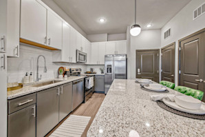 Kitchen with two toned cabinetry and stainless steel appliances at Camden Brandon apartments in Brandon, FL