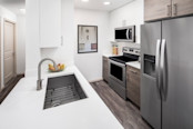 Gourmet kitchen with quartz countertops and single-basin undermount sink at Camden Potomac Yard apartments in Arlington, VA