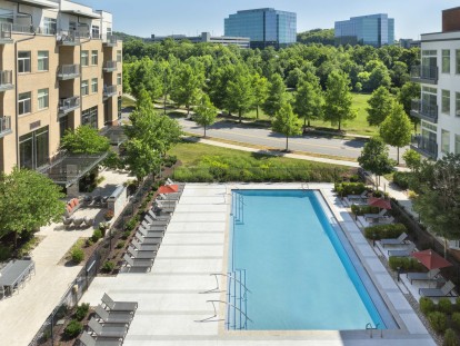 View of resort-style pool and sundeck looking toward Franklin business park near Camden Franklin Park apartments in Franklin, TN