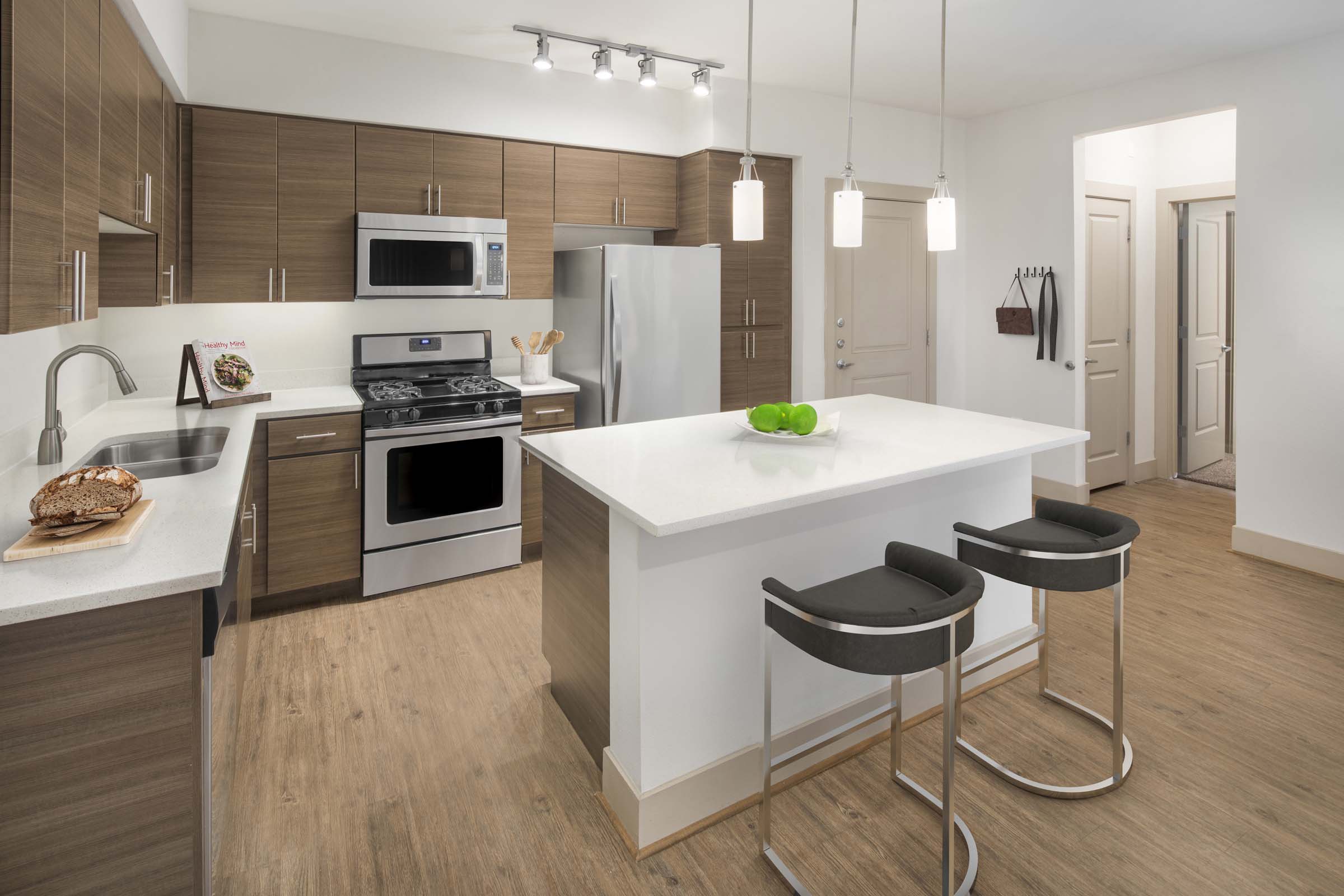 Camden Foothills Apartments Scottsdale AZ open concept kitchen with stainless steel appliances and island