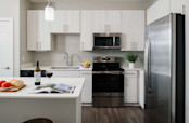 Kitchen with modern finishes and stainless steel appliances at Camden at Lake Nona in Orlando, FL.