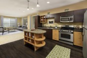 Open concept kitchen with two toned cabinetry and stainless steel appliances