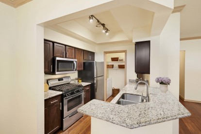 Kitchen with gas cooktop alongside laundry with full size washer and dryer