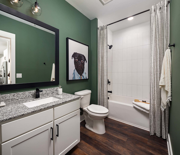 Bathroom with granite countertop and tile surrounded bathtub at Camden West Nashville apartments in Nashville, TN