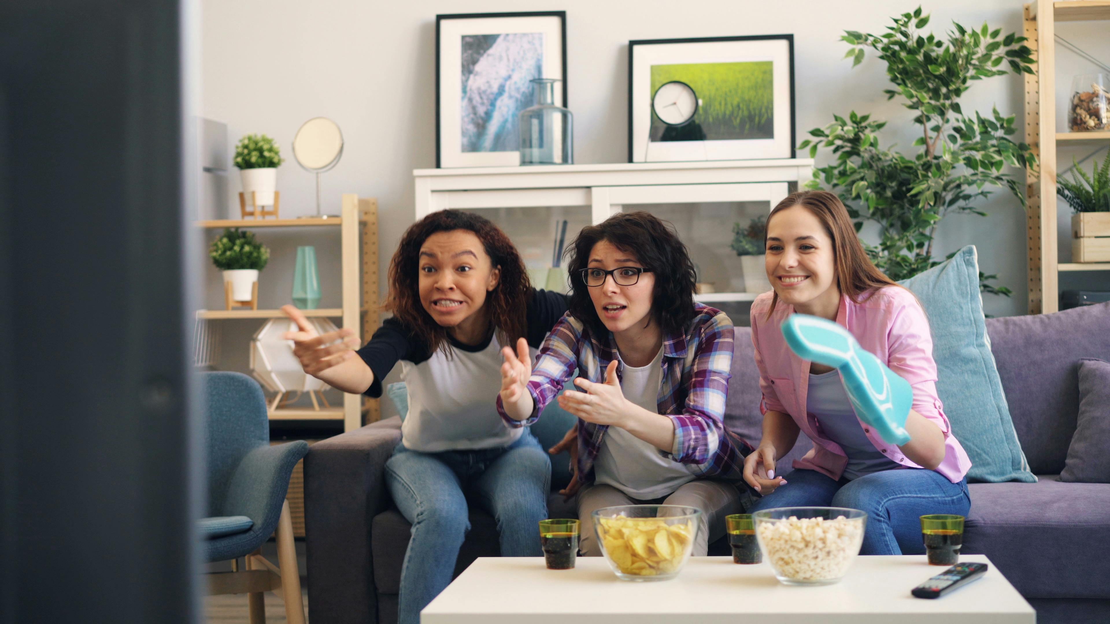 https://www.pexels.com/photo/three-women-sitting-on-a-couch-watching-tv-23495493/