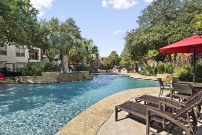 Resort-style pool with poolside seating at Camden Buckingham