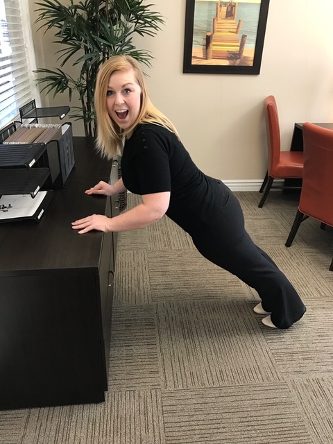 Kailey doing push-ups on the filing cabinet