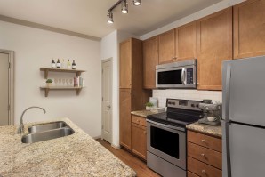 Kitchen with white subway-tile backsplash and granite countertops at Camden Amber Oaks