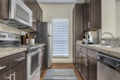 Kitchen with granite style countertops and wood look flooring