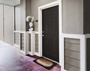 Apartment entrance with door bell and welcome mat